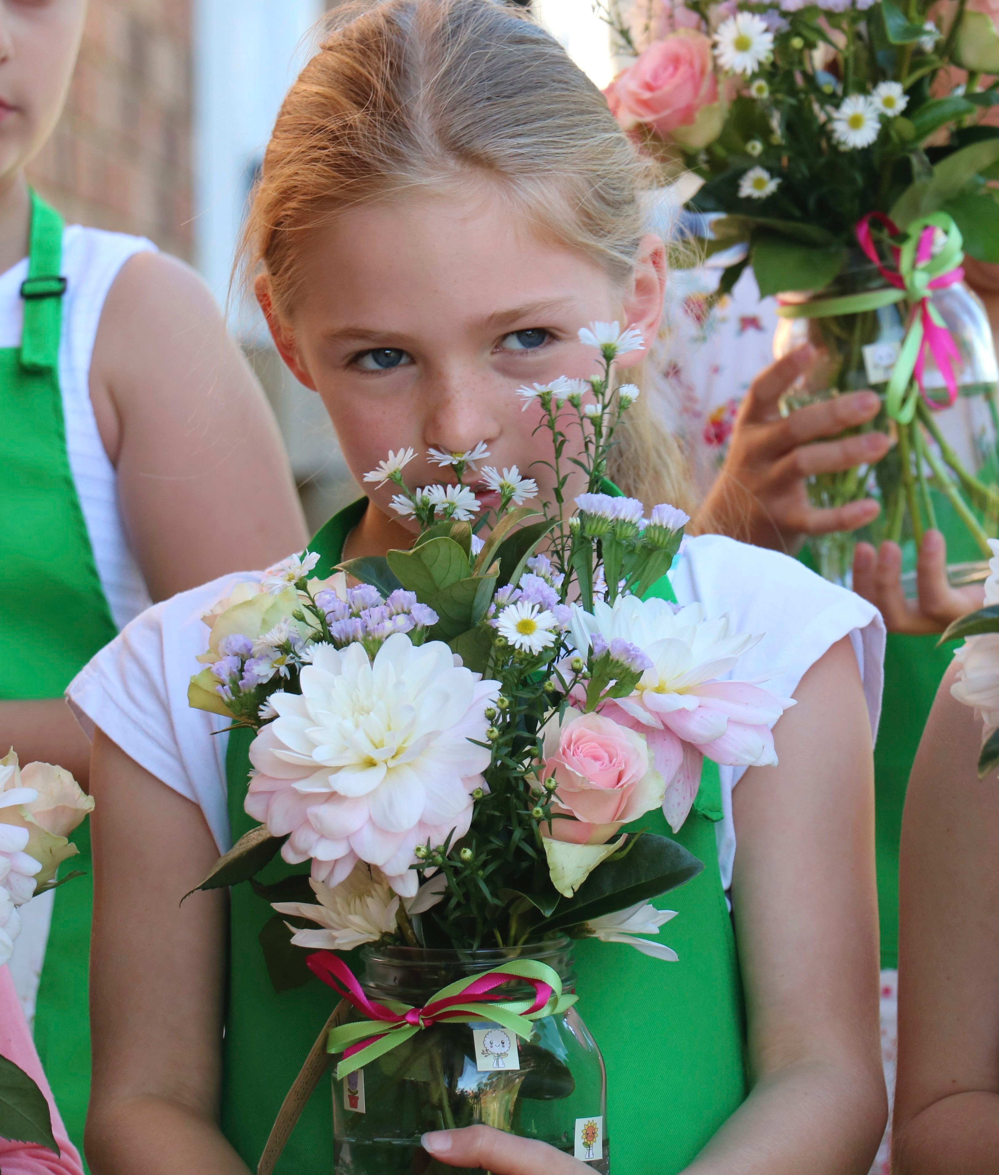 Young girl with flower arrangement by Graceful Blooms Mortdale events florist